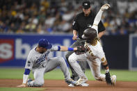 San Diego Padres' Fernando Tatis Jr. (23) steals second base ahead of the tag of Los Angeles Dodgers second baseman Gavin Lux (9) during the third inning of a baseball game Wednesday, June 23, 2021, in San Diego. (AP Photo/Denis Poroy)