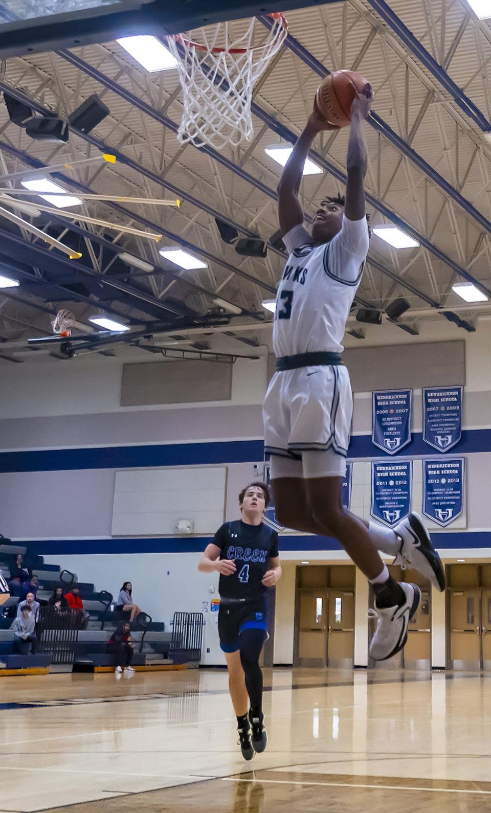 Hendrickson guard Amir Thompson is airborne for a dunk against Cedar Creek in the third quarter Thursday. He followed it up with a two-handed windmill slam in the fourth that sparked a big run by the Hawks.