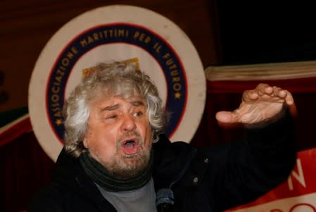 FILE PHOTO: 5-Star Movement founder Beppe Grillo gestures as he talks during a political rally with Luigi Di Maio in Torre del Greco, near Naples