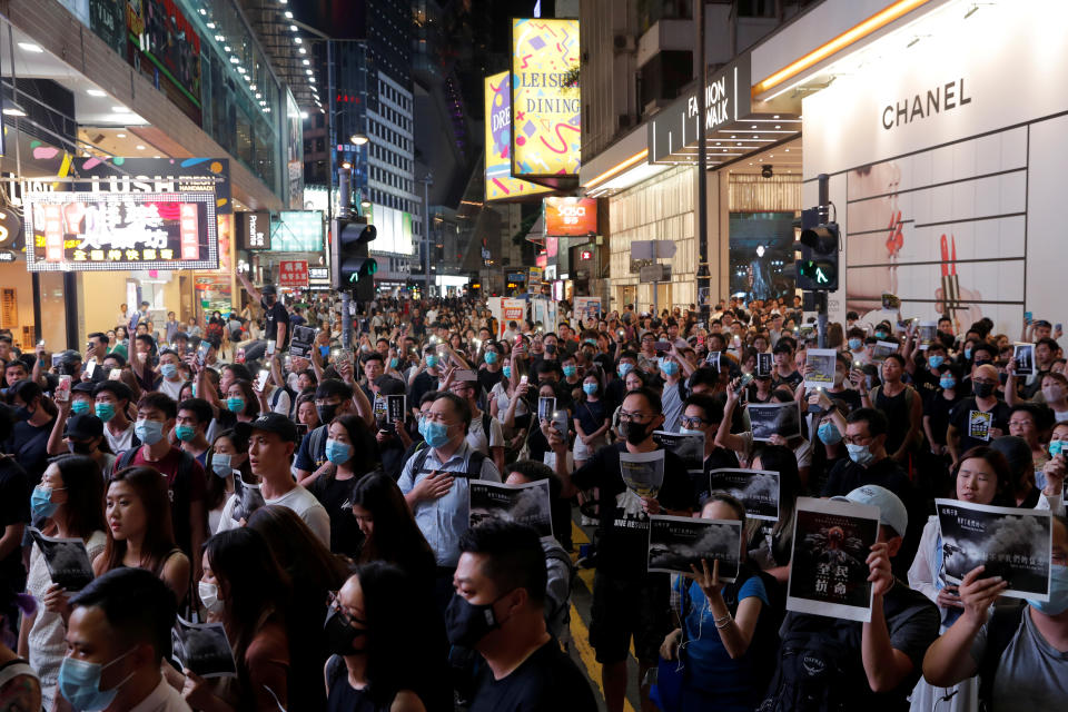 People attend a march in Causeway Bay in solidarity with the student protester who got shot by police with live ammunition in Hong Kong, China October 2, 2019. REUTERS/Susana Vera