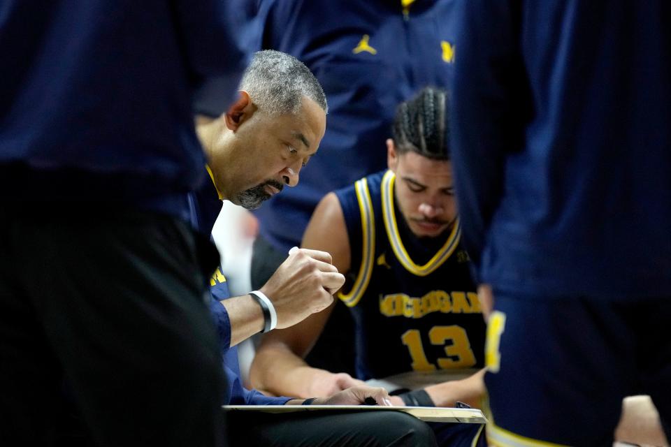 Michigan head coach Juwan Howard draws up a play during a timeout in the first half against Illinois at State Farm Center in Champaign, Illinois, on Tuesday, Feb. 13, 2024.