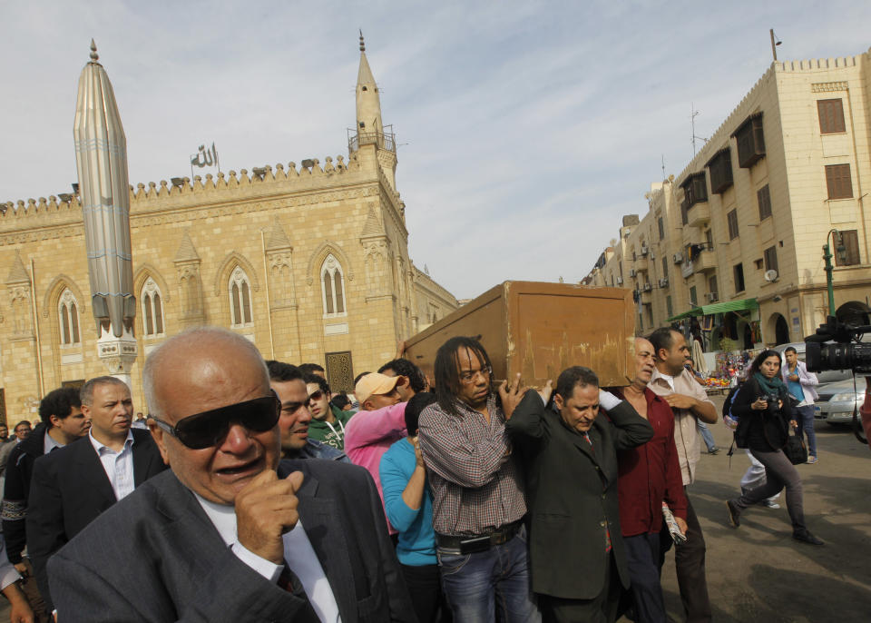 Mourners grieve during the funeral of Egypt’s best known satirical poet, Ahmed Fouad Negm, 84, as his coffin is carried outside al-Hussein mosque in Cairo, Egypt, Tuesday, Dec. 3, 2013. Known as the "poet of the people," Negm's use of colloquial Egyptian Arabic endeared him to his countrymen who saw in his verse an unvarnished reflection of how they felt about milestones in their nation's history like the humiliating defeat at the hands of Israel in 1967, the 1979 peace treaty with Israel and the authoritarian rule of Hosni Mubarak. (AP Photo/Amr Nabil)