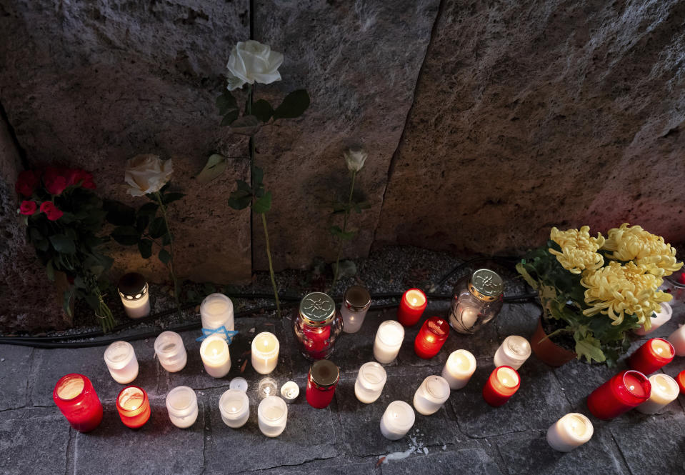 Candles and flowers are placed in front of the synagogue during an act of celebration and remembrance to mark the 20th anniversary of the main synagogue "Ohel Jakob" and to commemorate the pogrom night, in Munich, Germany, Thursday, Nov. 9, 2023. It was Nov. 9, 1938, or Kristallnacht — the “Night of Broken Glass” — when Nazis terrorized Jews throughout Germany and Austria. On the 85th anniversary of Kristallnacht today, Charlotte Knobloch still remembers that night with horror and says it will be burned into her memory forever. (Sven Hoppe/dpa via AP)