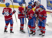 Montreal Canadiens goaltender Cayden Primeau (30) is congratulated on his shutout win against the Columbus Blue Jackets, following an NHL hockey game Tuesday, March 12, 2024, in Montreal. (Christinne Muschi/The Canadian Press via AP)