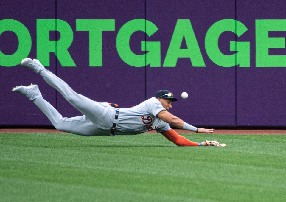 Detroit Tigers center fielder Victor Reyes can't catch a fly ball hit by Cleveland Indians' Cesar Hernandez during the first inning of a baseball game in Cleveland, Saturday, April 10, 2021.