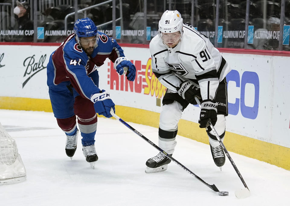 Colorado Avalanche center Pierre-Edouard Bellemare (41) steals the puck from Los Angeles Kings left wing Carl Grundstrom (91) during the first period of an NHL hockey game Wednesday, May, 12, 2021, in Denver. (AP Photo/Jack Dempsey)