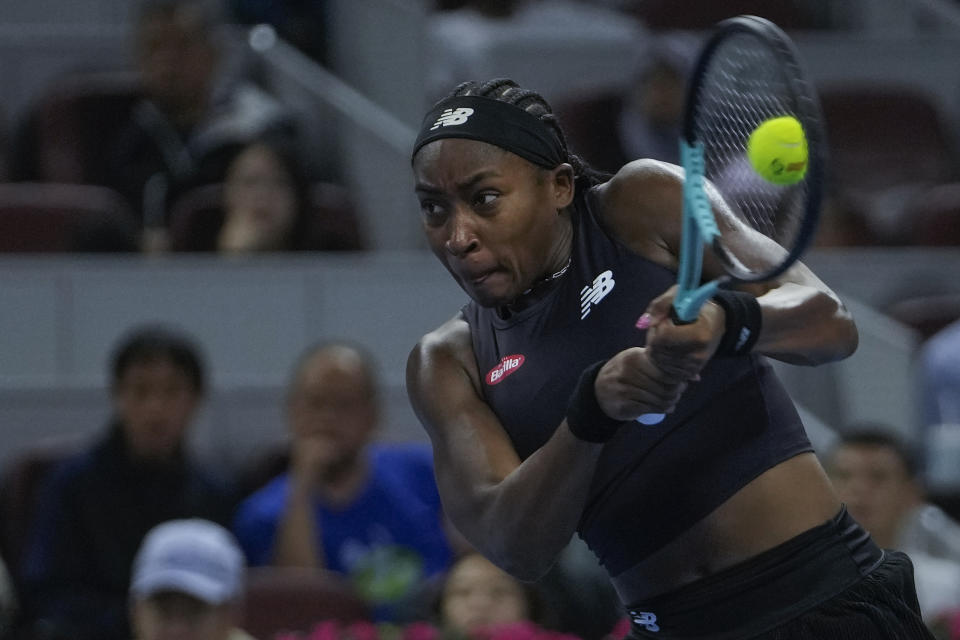 Coco Gauff of the United States hits a return shot against Petra Martic of Croatia during the 2nd round of the women's singles match in the China Open tennis tournament at the Diamond Court in Beijing, Tuesday, Oct. 3, 2023. (AP Photo/Andy Wong)