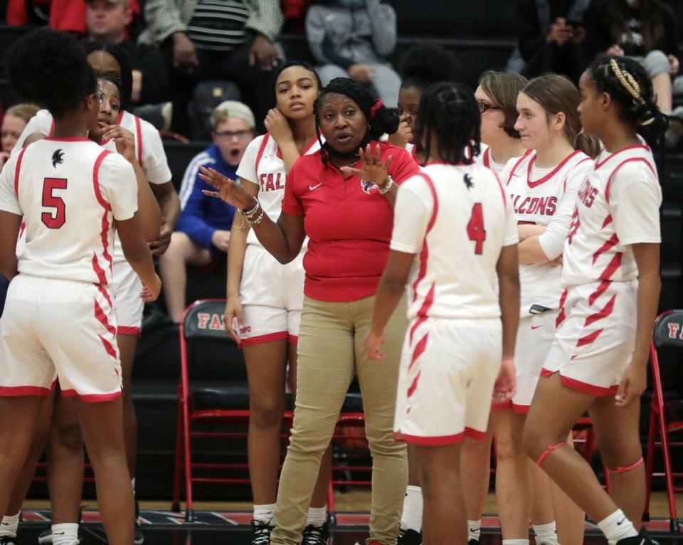 Nation Ford girls varsity basketball coach Coretta Ferguson Richmond talks to her team during a time out Friday as the Falcons and Blue Eagles compete in Fort Mill.