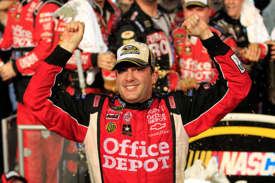 HOMESTEAD, FL - NOVEMBER 20: Tony Stewart, driver of the #14 Office Depot/Mobil 1 Chevrolet, celebrates in Victory Lane after winning the NASCAR Sprint Cup Series Ford 400 and the 2011 Series Championship at Homestead-Miami Speedway on November 20, 2011 in Homestead, Florida. Stewart wins his third NASCAR Championship. (Photo by Chris Trotman/Getty Images for NASCAR)