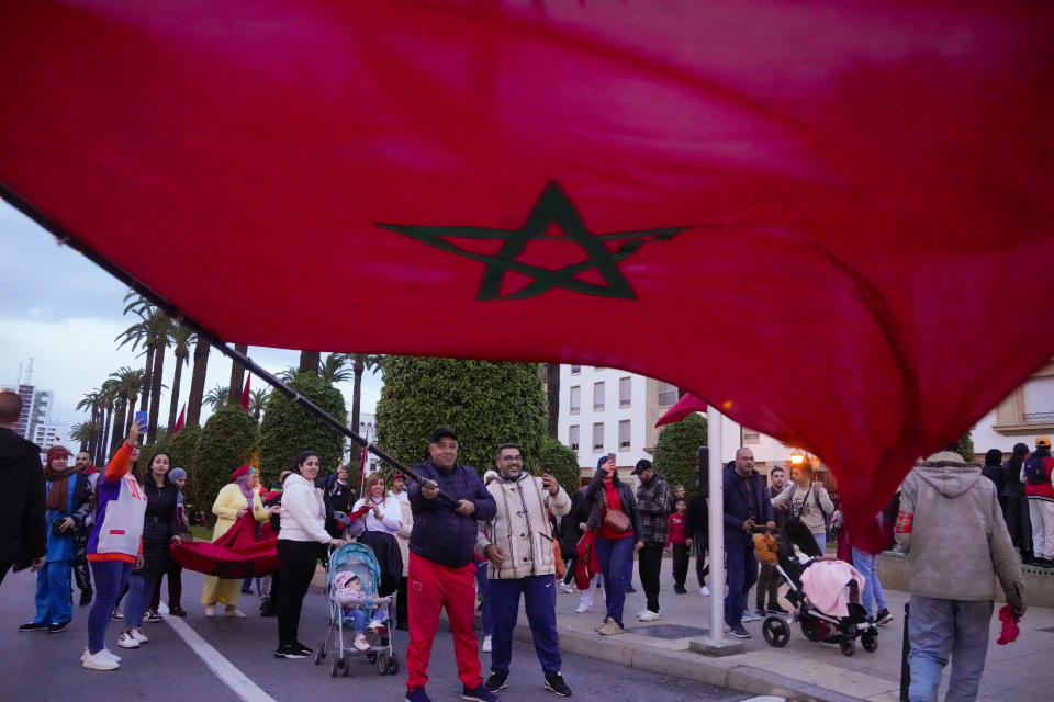 Moroccans celebrate in Rabat, Morocco, Saturday Dec. 10, 2022, after their team's victory against Portugal in the World Cup quarterfinal soccer match played in Qatar. (AP Photo/Mosa'ab Elshamy)