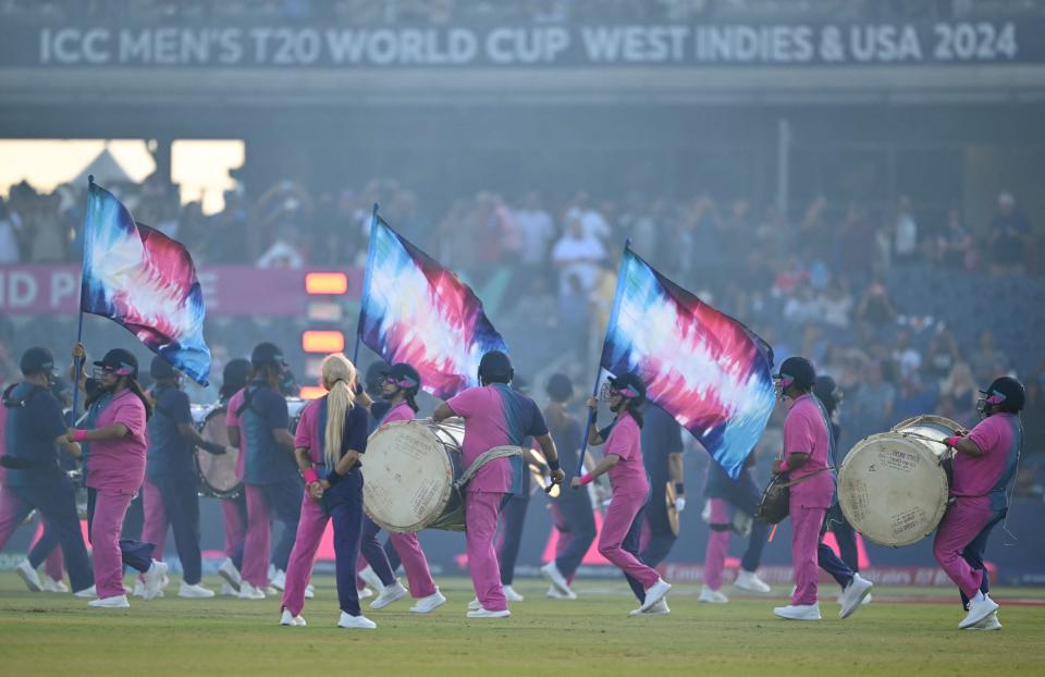 Flag bearers and musicians walk on the field during the opening ceremony ahead of the ICC men's Twenty20 World Cup 2024 opening match between the U.S. and Canada at the Grand Prairie Cricket Stadium in Grand Prairie, Texas on June 1, 2024.