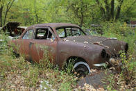 <p>In contrast to the Chevrolet, this 1951 Ford lives to see another day. Although its body panels are a lot straighter than the Chevy’s, a closer inspection reveals some serious corrosion issues. It has clearly been missing its windows for decades. The interior has rotted away, and now the seats are just <strong>exposed metal</strong>. </p>