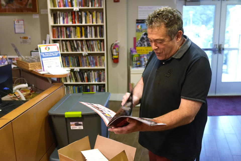 Robert Kesten, executive director of the Stonewall Museum, looks over a brochure the museum made to commemorate the 55 anniversary of the Stonewall uprising, Wednesday, June 26, 2024, in Fort Lauderdale, Fla. The Stonewall Museum hosts a comprehensive archive on LGBTQ+ history and the largest library collection in the world. The museum is one of hundreds of art and culture groups in the state that are left scrambling to plug a large budget gap after Gov. Ron De Santis vetoed $32 million in arts funding. (AP Photo/Marta Lavandier)