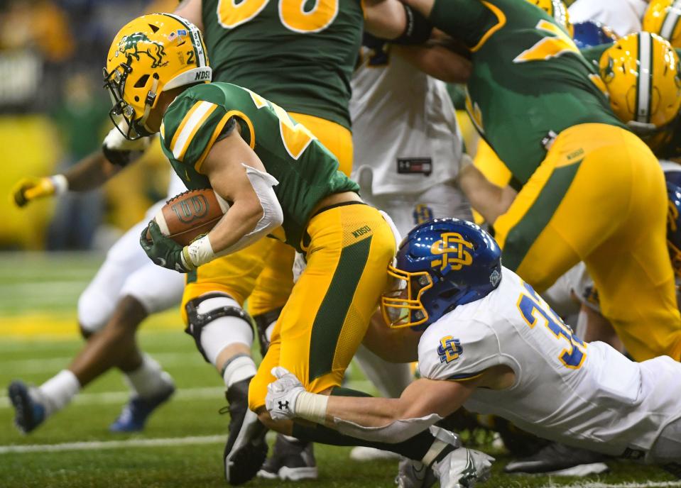 North Dakota State's Dominic Gonnella is tackled by South Dakota State's Adam Bock in the Dakota Marker rivalry game on Saturday, April 17, 2021, at the Fargodome in Fargo. 