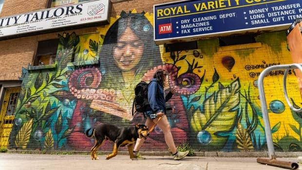 A person walks with their dog in Ottawa on May 11, 2021. (Brian Morris/CBC - image credit)