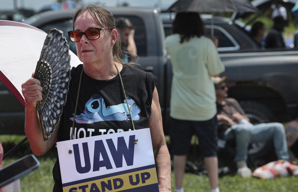 Assembly line worker Sheila Buckley tries to keep cool while on the picket line as members of United Auto Workers Local 282 are on strike against Lear, a car and truck seat manufacturer in Wentzville, Mo. on Tuesday, July 23, 2024. The strike led to a shutdown at the nearby GM assembly plant. (Robert Cohen/St. Louis Post-Dispatch via AP)