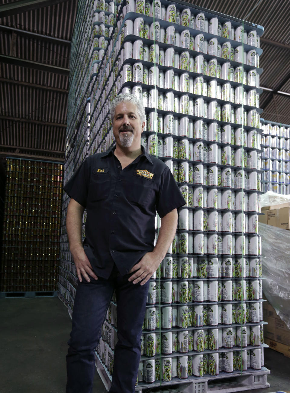 NOLA Brewing Co. LLC, CEO Kirk Coco stands in front of a stack of cans for their MechaHopzilla brand beer at the brewery in New Orleans, Tuesday, Sept. 10, 2013. The Japanese company that produced the classic Godzilla series of movies has sued the New Orleans brewery, claiming the MechaHopzilla beer brand infringes on its Mechagodzilla copyrights and trademarks. (AP Photo/Gerald Herbert)