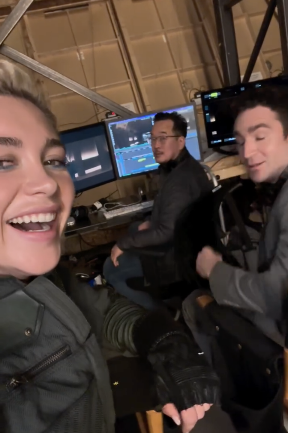 Florence Pugh with posing with monitors and equipment in the background