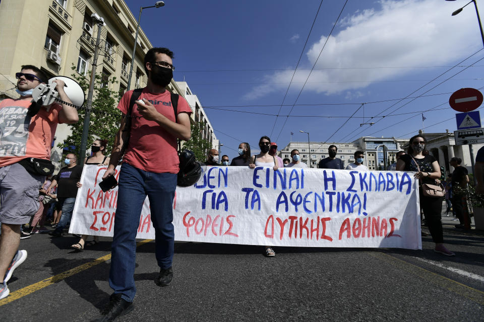 Protesters march to the parliament during a 24-hour labor strike in Athens, Thursday, June 10, 2021. Widespread strikes in Greece brought public transport and other services to a halt Thursday, as the country's largest labor unions protested against employment reforms they argue will make flexible workplace changes introduced during the pandemic more permanent. (AP Photo/Michael Varaklas)