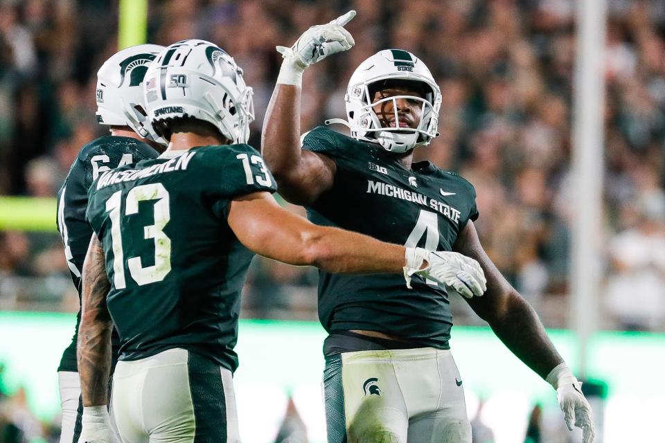 Michigan State linebacker Jacoby Windmon (4) celebrates a tackle against Western Michigan wide receiver Corey Crooms (4) during the second half at Spartan Stadium in East Lansing on Friday, Sept. 2, 2022.