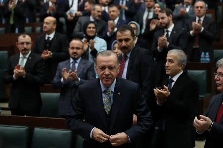 Turkish President Tayyip Erdogan leaves his seat to address members of parliament from his ruling AK Party (AKP) during a meeting at the Turkish parliament in Ankara, Turkey, January 15, 2019. REUTERS/Umit Bektas