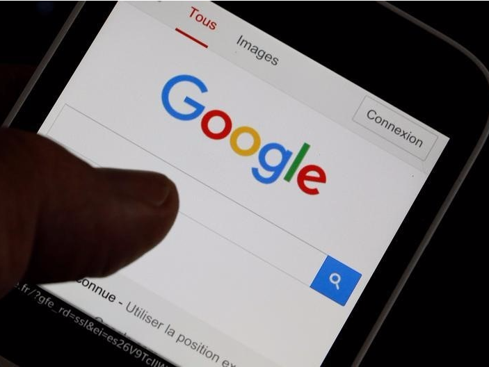 A man holds his smartphone which displays the Google home page, in this picture illustration taken in Bordeaux, Southwestern France, August 22, 2016. REUTERS/Regis Duvignau