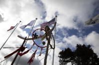 Native American dreamcatchers and an American flag wave in the wind prior to a ceremony at the Charles Shay World War II memorial at Omaha Beach in Saint-Laurent-sur-Mer, Normandy, France, Friday, June 5, 2020. Saturday's anniversary of D-Day will be one of the loneliest remembrances ever, as the coronavirus pandemic is keeping almost everyone away, from government leaders to frail veterans who might not get another chance for a final farewell to their unlucky comrades. Shay was a combat medic on D-Day, assigned to an assault battalion in the first wave of attacks on June 6, 1944. (AP Photo/Virginia Mayo)