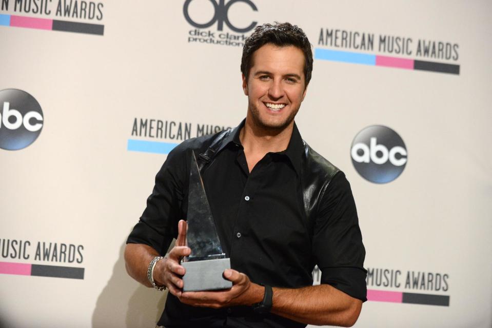 Luke Bryan poses backstage with the award for favorite male artist - country at the American Music Awards at the Nokia Theatre L.A. Live on Sunday, Nov. 24, 2013, in Los Angeles. (Photo by Jordan Strauss/Invision/AP)
