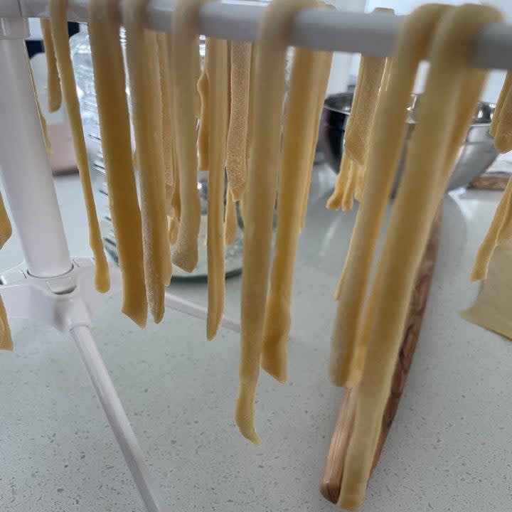 Homemade noodles hanging on a rack