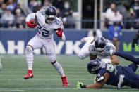 Tennessee Titans running back Derrick Henry (22) rushes against the Seattle Seahawks during the second half of an NFL football game, Sunday, Sept. 19, 2021, in Seattle. (AP Photo/Elaine Thompson)