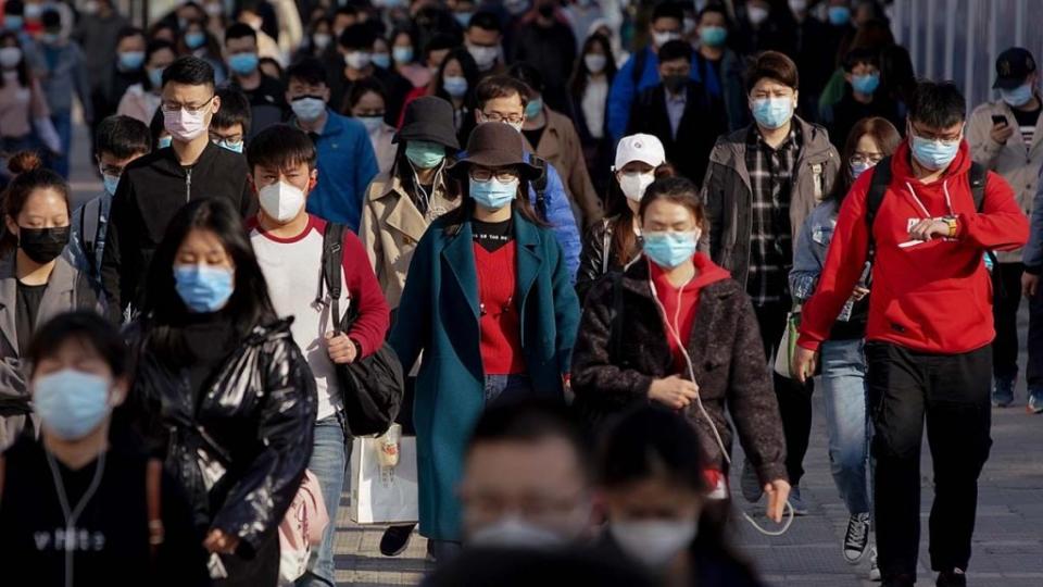 In this April photo, commuters in Beijing, China wear protective masks as they exit a train at a subway station during Monday rush hour. (Photo by Lintao Zhang/Getty Images)