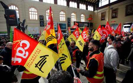 Railway workers hold CGT labour union flags as they demonstrate inside the Gare Saint-Charles train station on the second day of a nationwide strike by French SNCF railway workers, in Marseille, France, April 4, 2018. REUTERS/Jean-Paul Pelissier