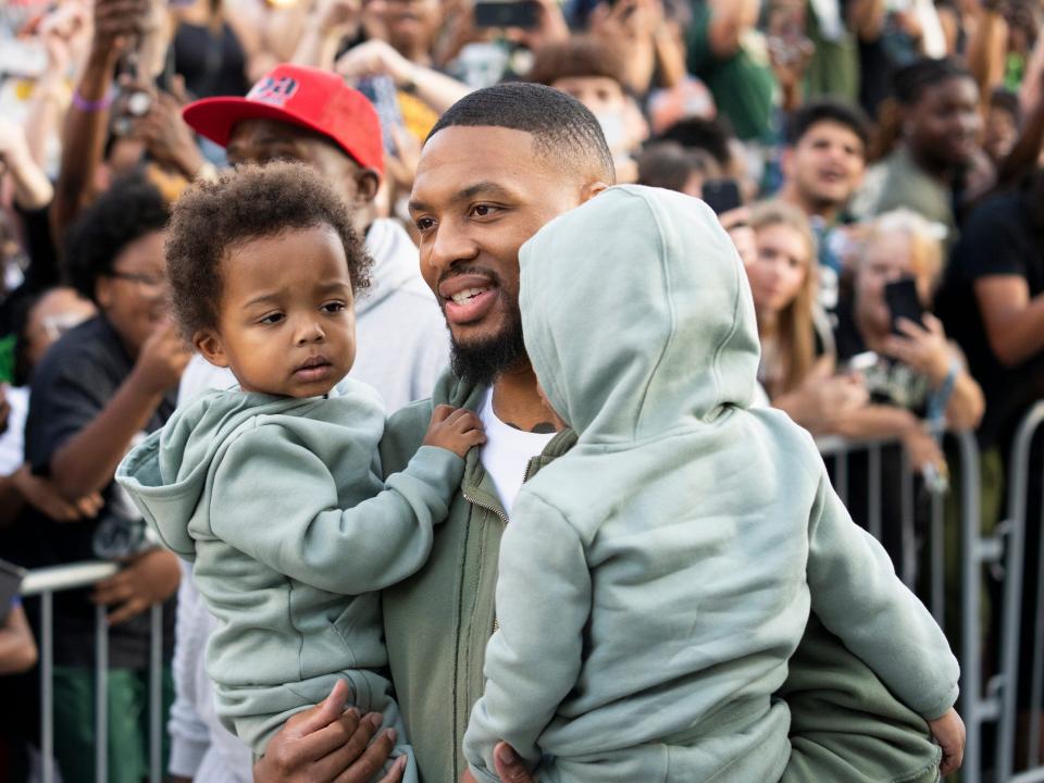 Damian Lillard arrives in Milwaukee with his kids.