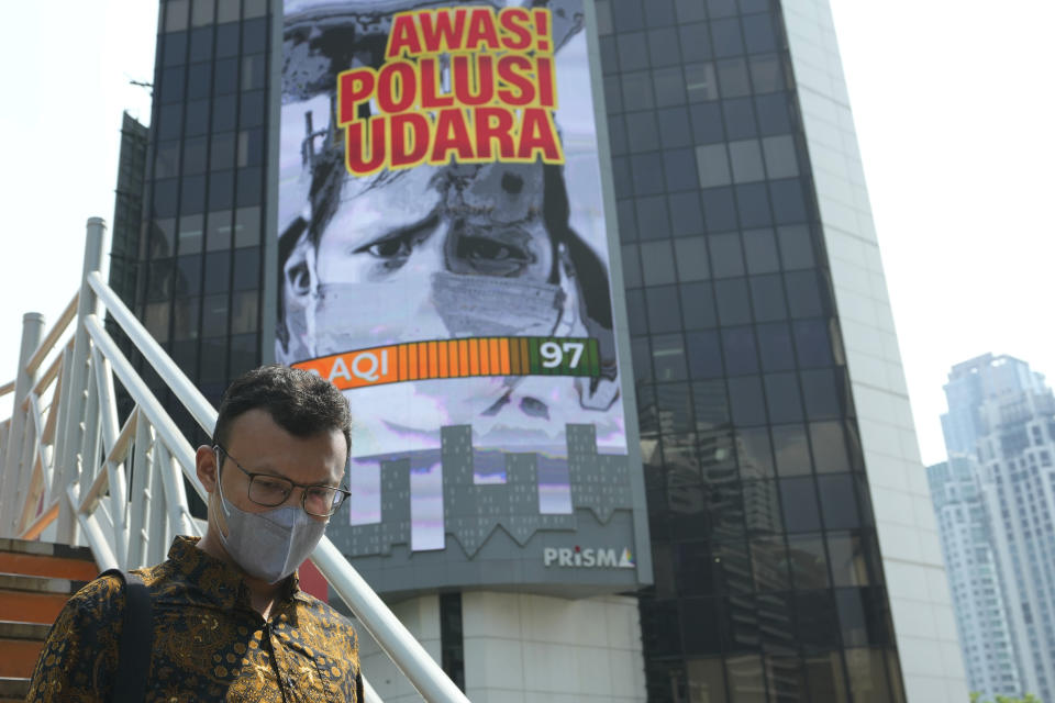 A man walks on a bridge past a billboard that says "Beware of Air Pollution" at the main business district in Jakarta, Indonesia, on Oct. 3, 2023. Pollution is causing respiratory illnesses and deaths to rise in Indonesia's island of Java, including the capital, Jakarta. Data gathered by IQAir, a Swiss air technology company, regularly ranks Jakarta as one of the most polluted cities in the world. Blue skies are a rare sight and the air often smells like fuel or heavy smoke. (AP Photo/Achmad Ibrahim)