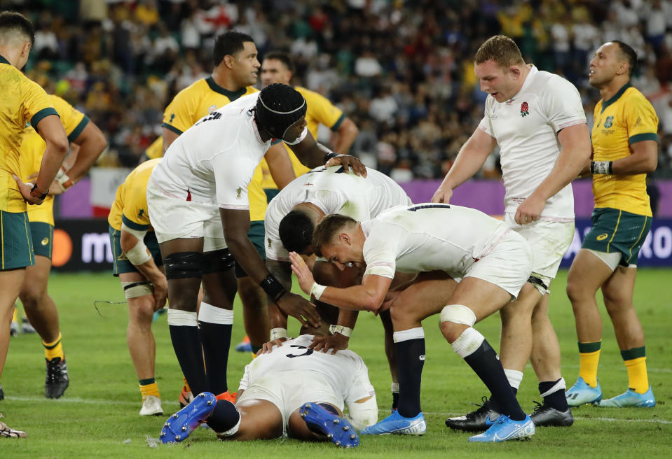 England's Kyle Sinckler, bottom, celebrates with teammates after scoring a try against Australia during the Rugby World Cup quarterfinal match at Oita Stadium in Oita, Japan, Saturday, Oct. 19, 2019.(AP Photo/Christophe Ena)