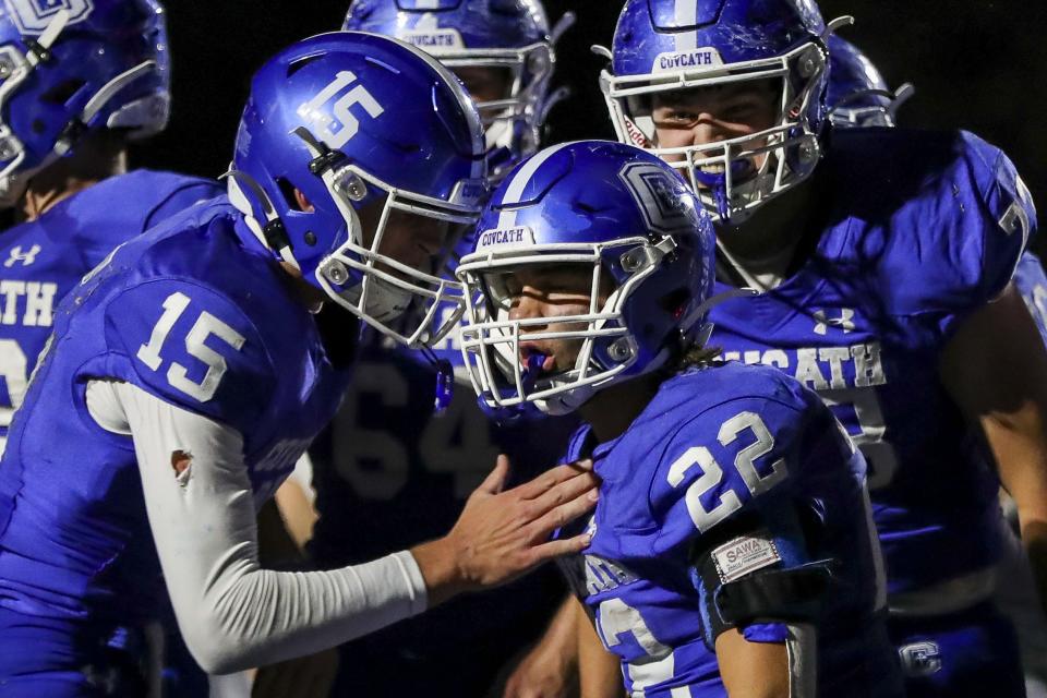 Covington Catholic running back Owen Leen (22) reacts after scoring a touchdown with quarterback Evan Pitzer (15) in the second half against Highlands Friday.