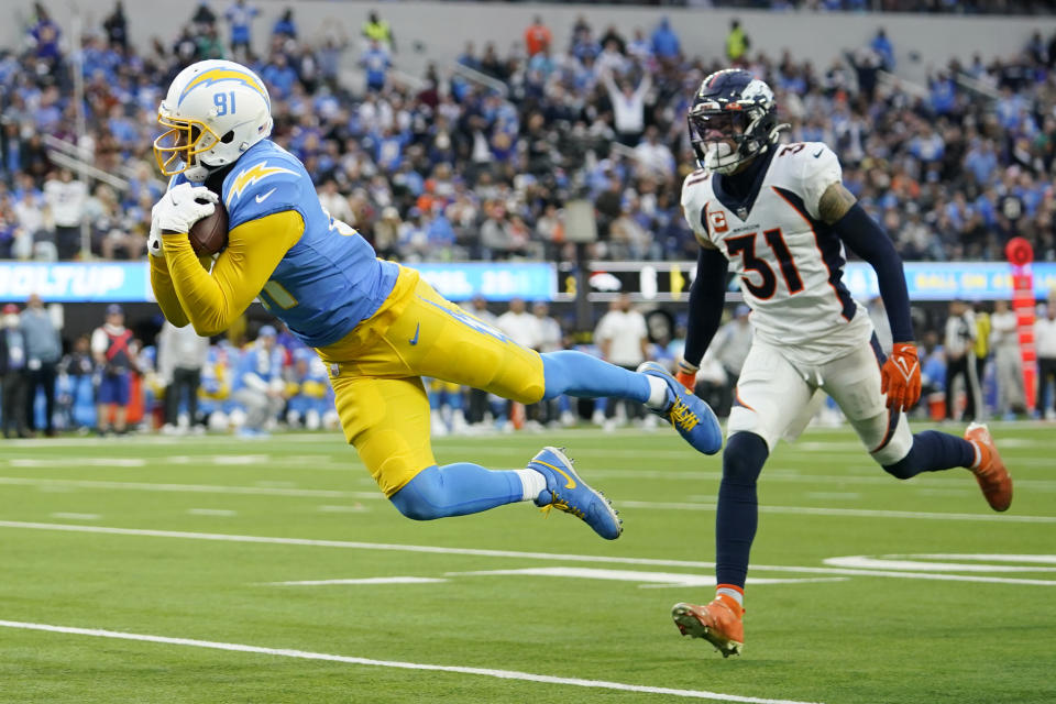 Los Angeles Chargers wide receiver Mike Williams (81) catches a touchdown in front of Denver Broncos free safety Justin Simmons (31) during the second half of an NFL football game Sunday, Jan. 2, 2022, in Inglewood, Calif. (AP Photo/Jae C. Hong )