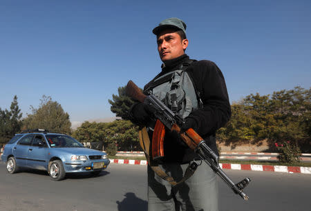 An Afghan policeman stands guard at a checkpoint a day before parliamentary elections in Kabul, Afghanistan October 19, 2018. REUTERS/Omar Sobhani