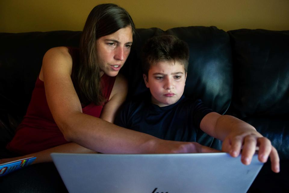 Cassie Atallah and her son, Kai, work on a coding project during a homeschool lesson on Friday, Sept. 9, 2022.