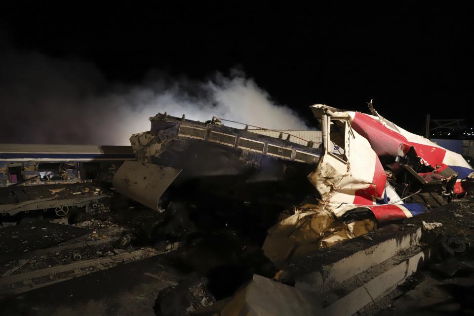 Smoke rises from trains after a collision near Larissa city, Greece, early Wednesday, March 1, 2023. The collision between a freight and passenger train occurred near Tempe, some 380 kilometers (235 miles) north of Athens, and resulted in the derailment of several train cars. (AP Photo/Vaggelis Kousioras)