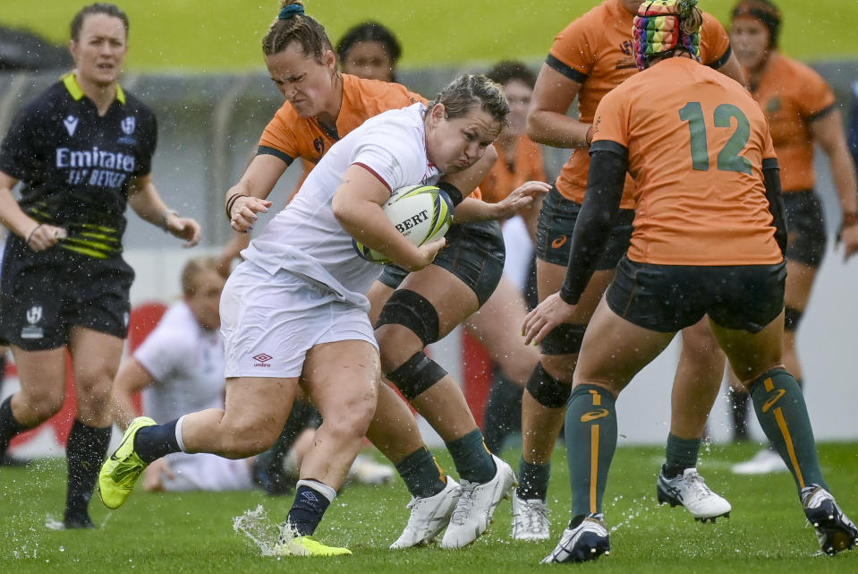 England's Marlie Packer runs at the defense during the women's rugby World Cup quarterfinal against Australia at Waitakere Stadium in Auckland, New Zealand, Sunday Oct. 30 2022. (Andrew Cornaga/Photosport via AP)