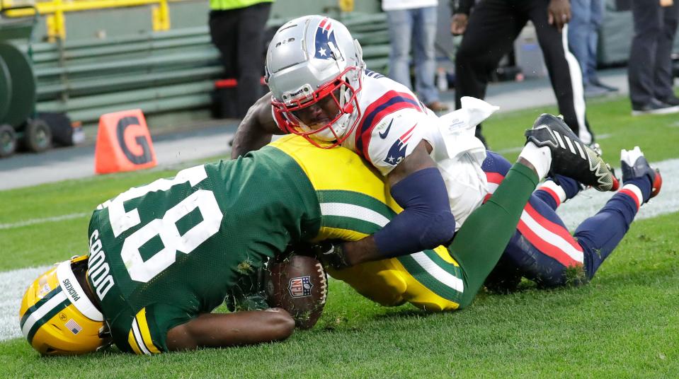 Packers rookie receiver Romeo Doubs tries to secure a touchdown pass from Aaron Rodgers against the Patriots' Jonathan Jones, but it was ruled incomplete because Doubs didn't maintain control.