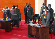 Mozambican President Filipe Nyusi, left, and Zimbabwe President Emmerson Mnangagwe, right, join Southern African leaders during a meeting in Mozambique's capital Maputo, Thursday, April 8, 2021. Leaders met to discuss ways to respond to the violence by Islamic extremist rebels in the country's northern Cabo Delgado province where thousands of people have been killed and displaced. (AP Photo/Ferhat Momade)