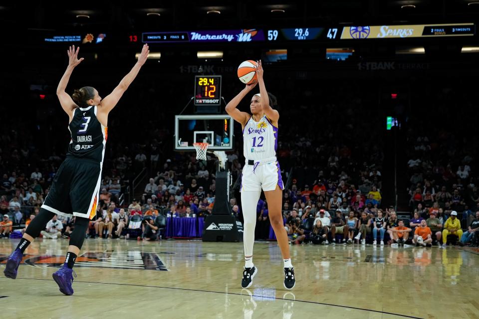 Rae Burrell (12) of the Los Angeles Sparks goes to shoot as Diana Taurasi (3) of the Phoenix Mercury jumps up to block her in a game at the Footprint Center on July 9, 2023, in Phoenix.