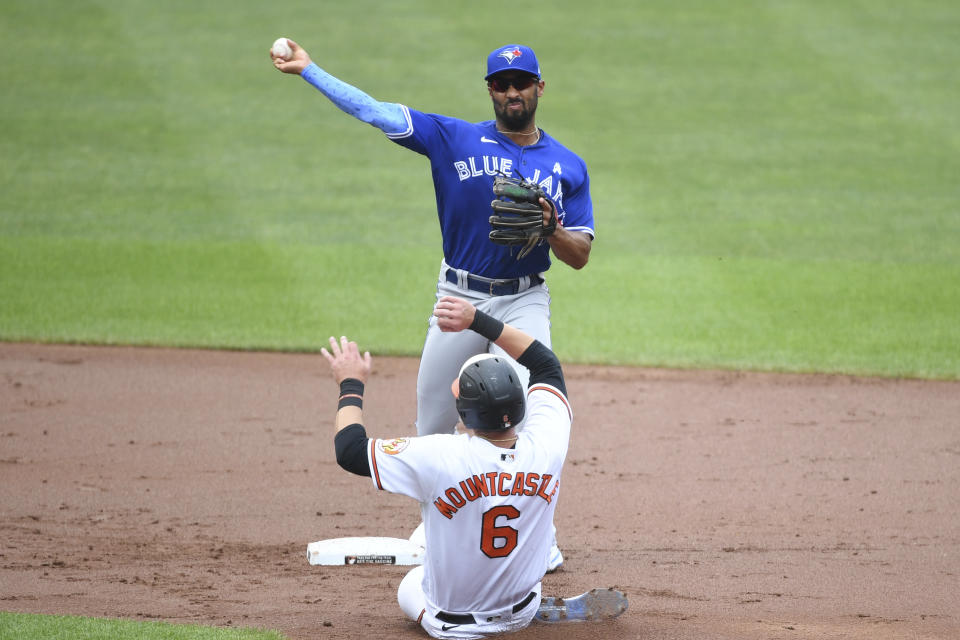 Toronto Blue Jays second baseman Marcus Semien turns a double play during the first inning as Ryan Mountcastle slides into second base baseball game on Sunday, June 20, 2021, in Baltimore. (AP Photo/Terrance Williams)