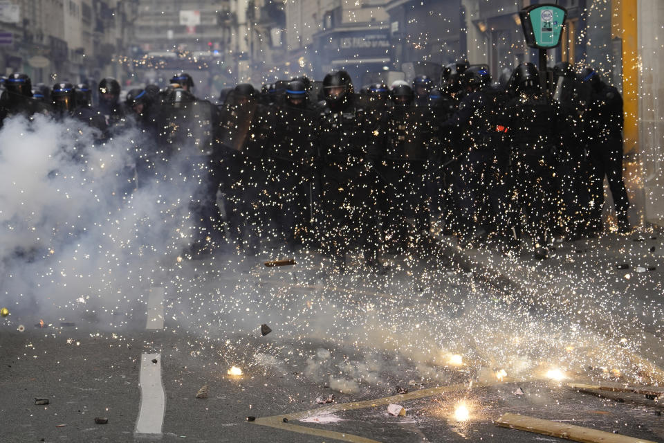 Riot police officers take position during clashes as part of a demonstration in Paris, Tuesday, March 7, 2023. Demonstrators were marching across France on Tuesday in a new round of protests and strikes against the government's plan to raise the retirement age to 64, in what unions hope to be their biggest show of force against the proposal. (AP Photo/Lewis Joly)