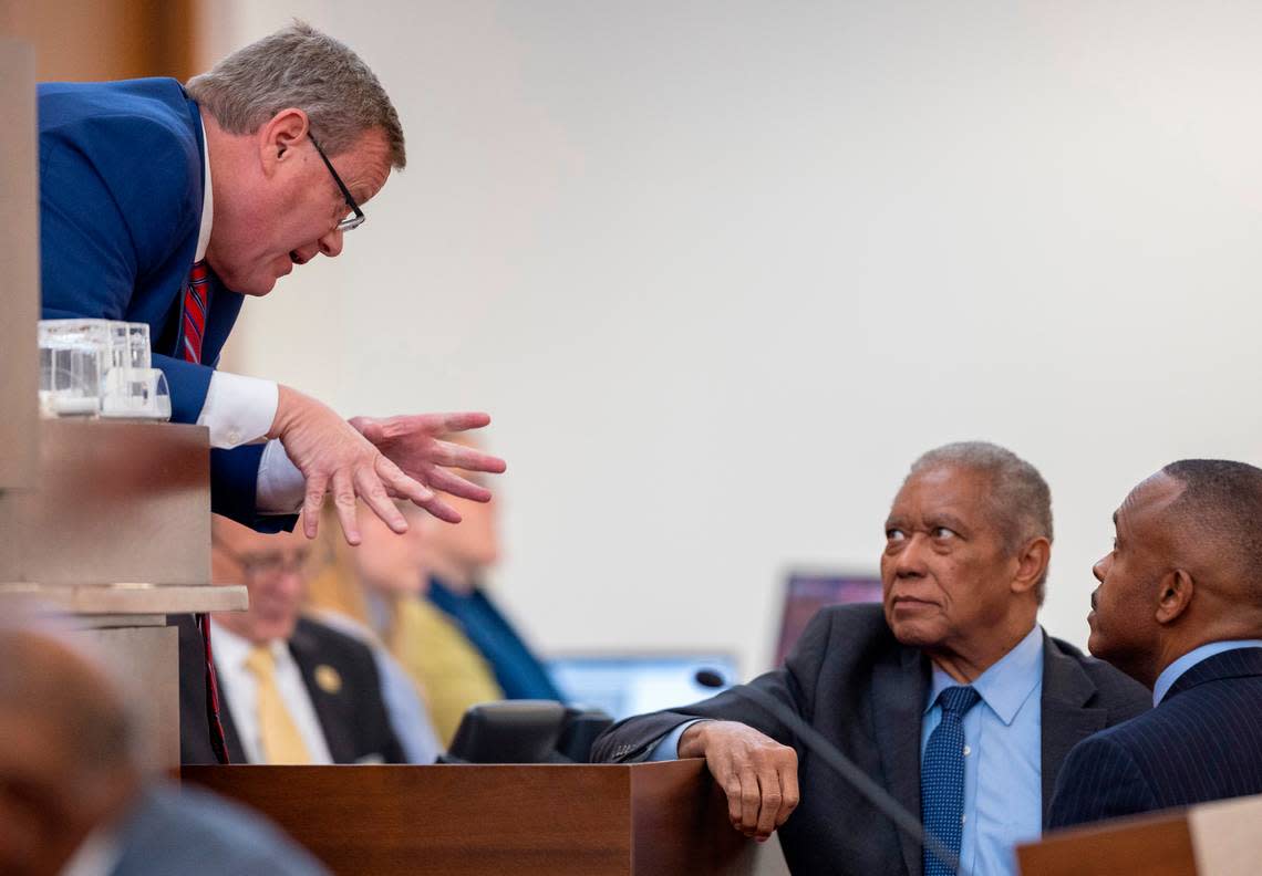House Speaker Tim Moore talks with Sen. Dan Blue and Rep. Robert Reives at the dais on the House floor during debate of House Bill 898 on redistricting, on Tuesday, October 24, 2023 in Raleigh, N.C.