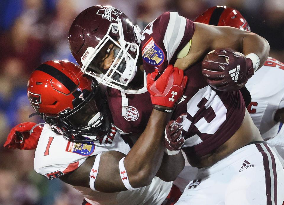 Texas Tech Red Raiders linebacker Krishon Merriweather drags down Mississippi State Bulldogs running back Dillon Johnson during the AutoZone Liberty Bowl at Liberty Bowl Memorial Stadium on Tuesday, Dec. 28, 2021.