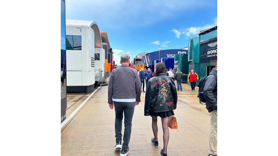 father and daughter walking down concrete path