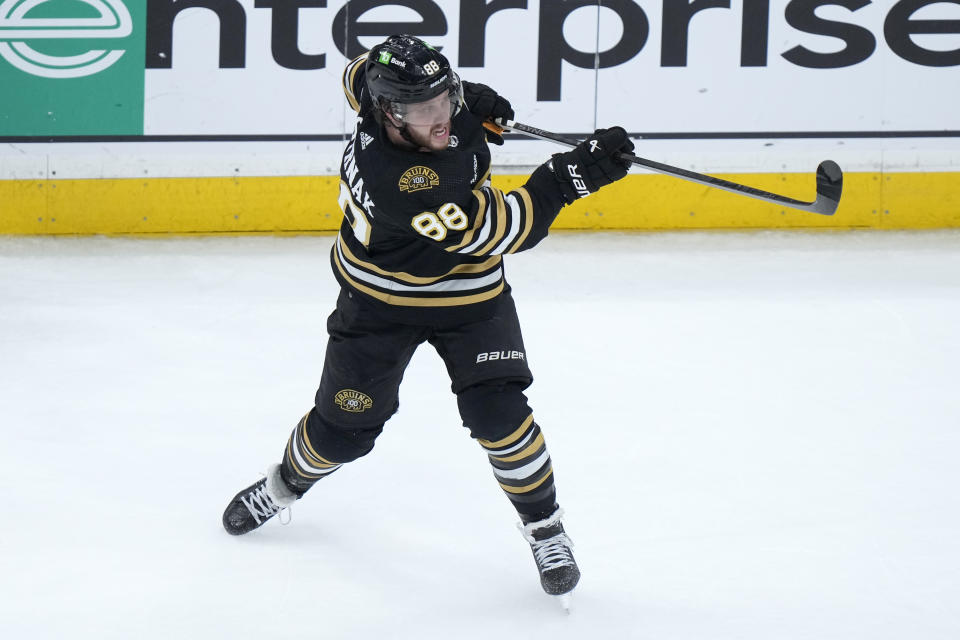 Boston Bruins right wing David Pastrnak shoots at the goal during the third period of an NHL hockey game against the Colorado Avalanche, Thursday, Jan. 18, 2024, in Boston. (AP Photo/Steven Senne)